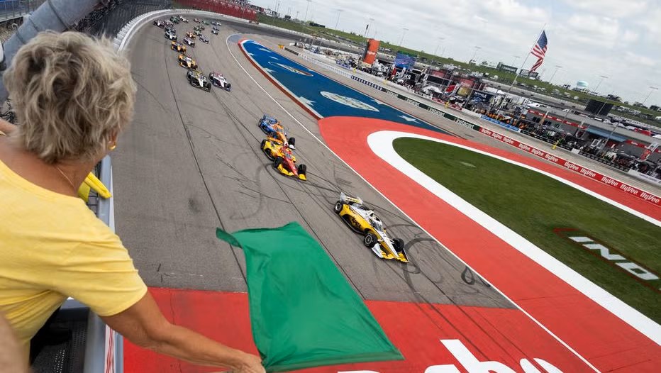 lisa-bluder-former-iowa-women-s-basketball-coach-waves-the-green-flag-hy-vee-indycar-race-weekend-hy-vee-one-step-250-by-travis-hinkle-ref-image-without-watermark-m112916-686c0bc12678a.jpg