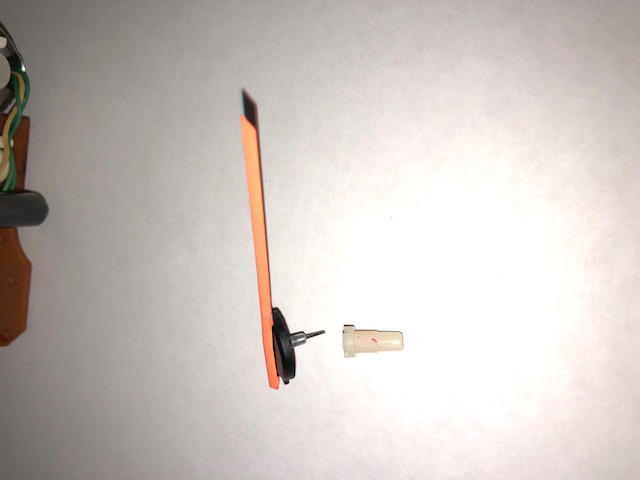 Needle with center pin still attached after being pulled out of plastic screw